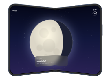 The partially folded inner display of iPhone Duo with the card still layered over the moon, both lying across the fold